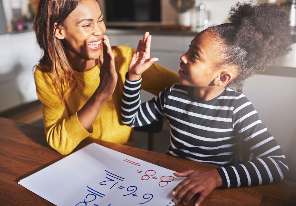 parent and child give high five